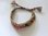 ibiza geknoopte verstelbare armband versierd met goudkleurige kettingkjes